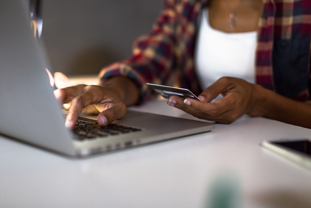Woman sitting at a computer learning how to build credit.